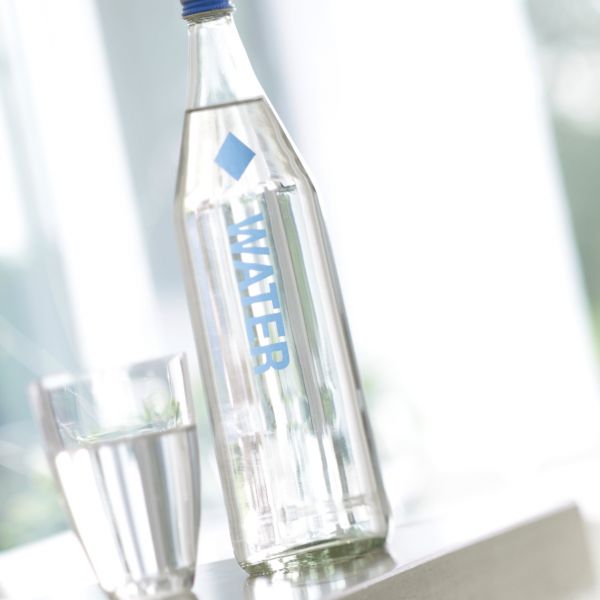 Water bottle and glas on table