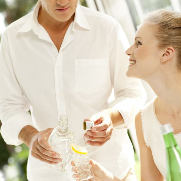 Man serving drink to woman