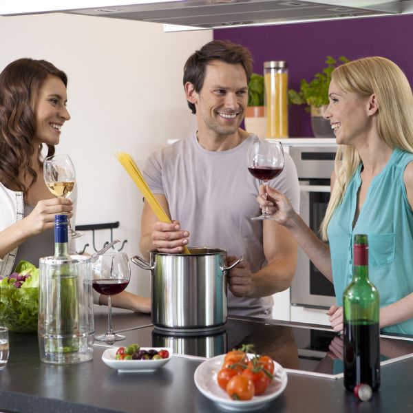 People drinking wine and cooking