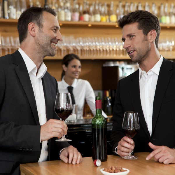 two men drinking wine